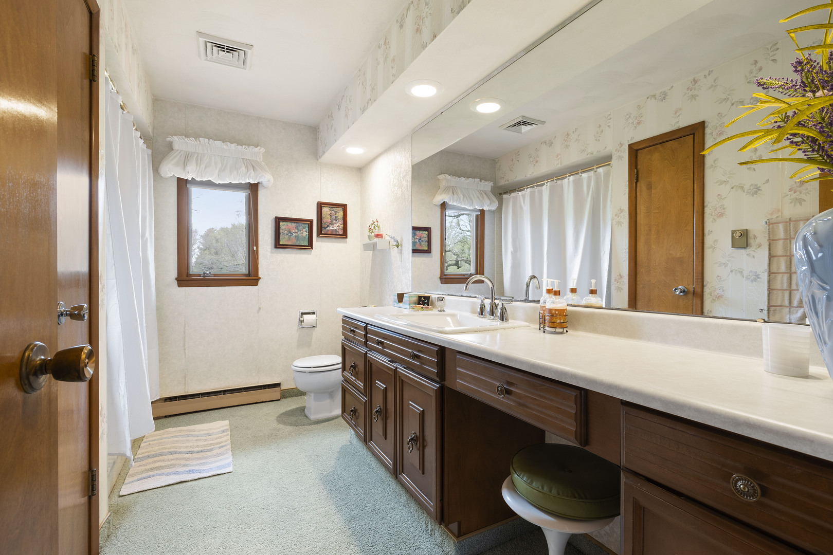 5812 Rotary Road Cherry Valley, IL 61016 - Photo 14 of 28 a spacious bathroom with a double vanity sink a toilet and a mirror