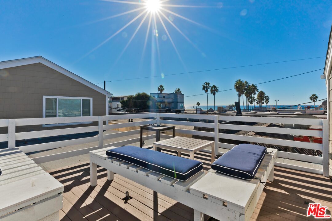 a roof deck with patio table and chairs