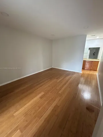 a view of a room with wooden floor