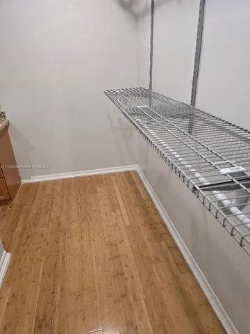 a view of a kitchen with wooden floor