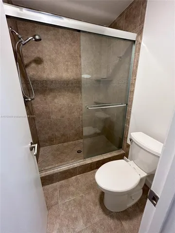 a bathroom with a toilet and a shower