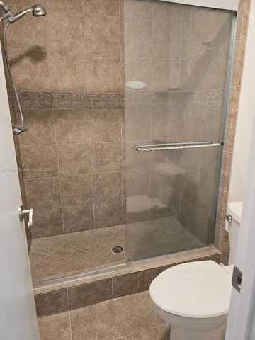 a bathroom with a shower and toilet