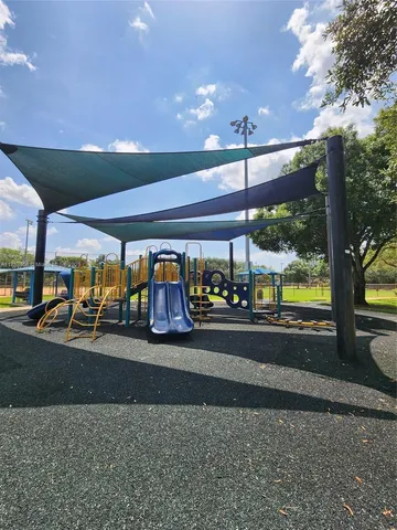 a view of a park with large trees