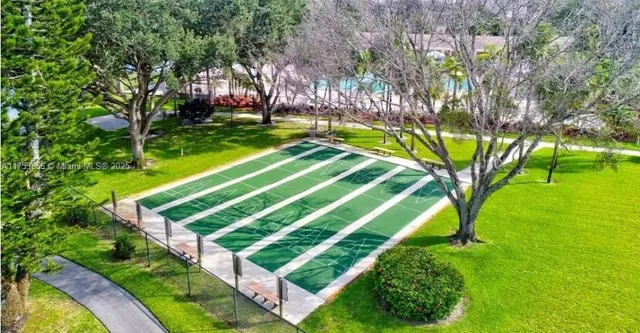 a view of a playground with a garden and entertaining space