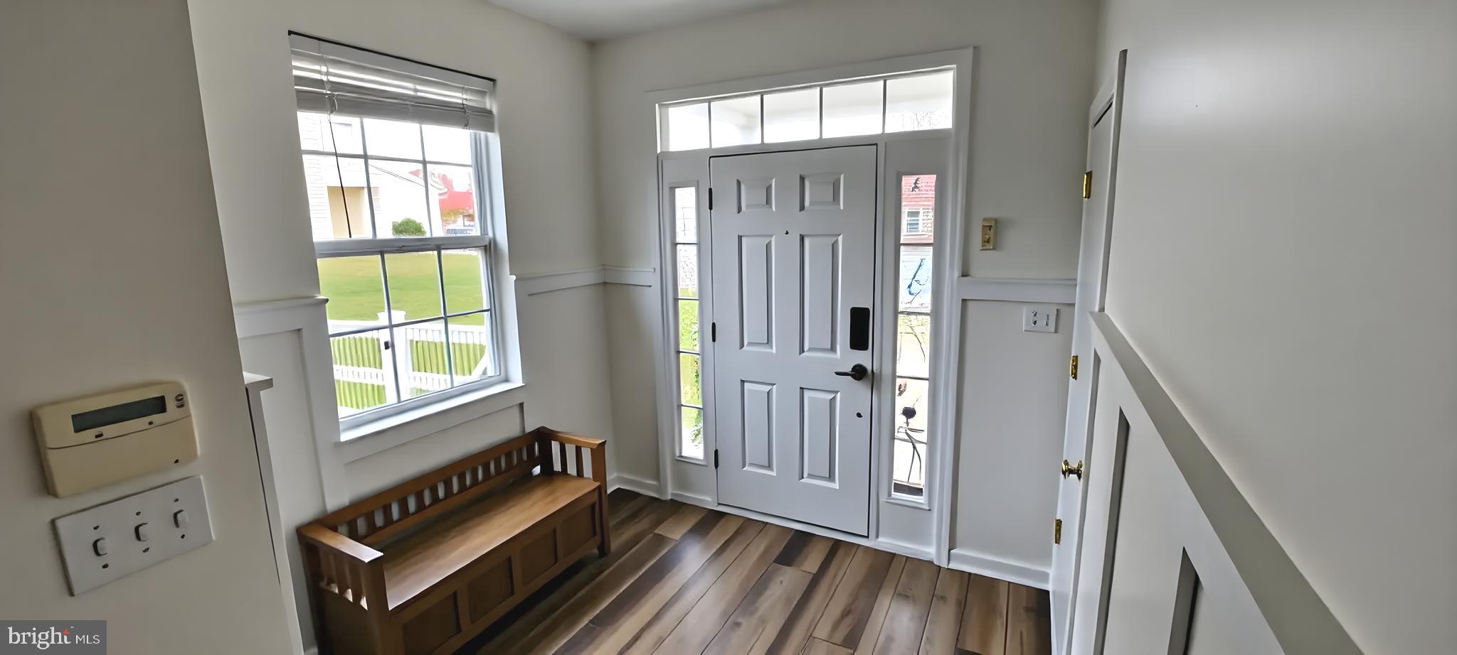 919 Lansdowne Road Middletown, DE 19709 - Photo 2 of 9 a view of an entryway with wooden floor and windows