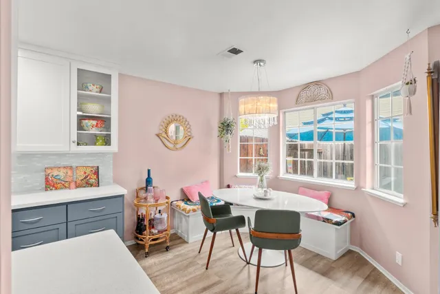 a kitchen with stainless steel appliances a sink dishwasher stove refrigerator and couches with wooden floor