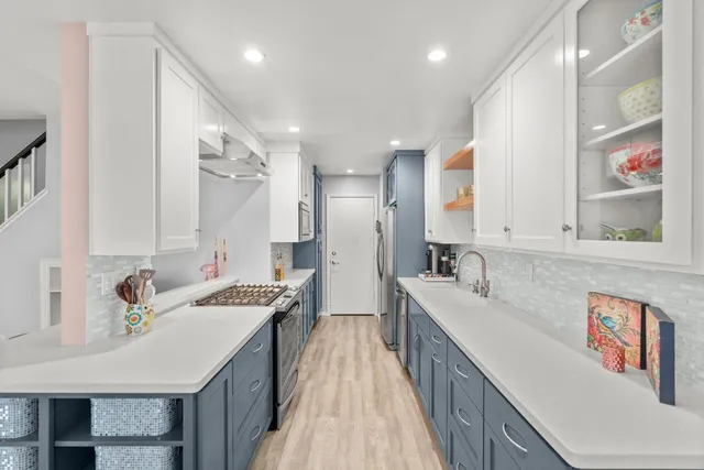 a kitchen with a stove and a refrigerator