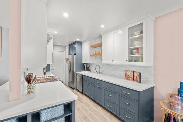 a kitchen with stainless steel appliances granite countertop a sink stove and cabinets