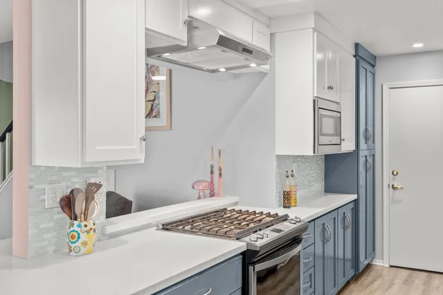 a kitchen with stainless steel appliances a refrigerator and a stove