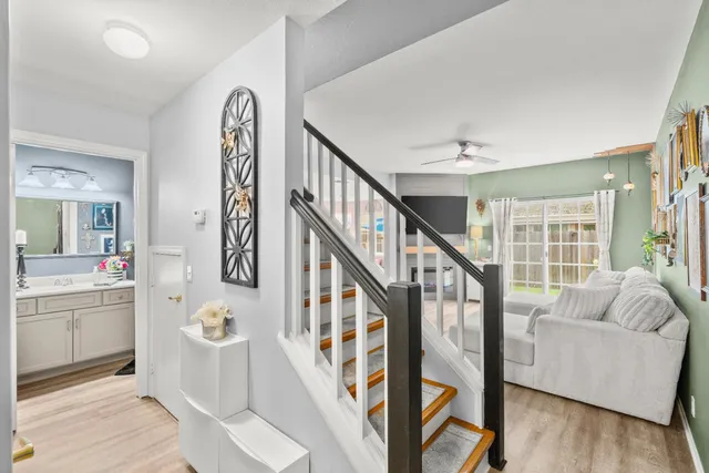 a view of a hallway with wooden floor and staircase