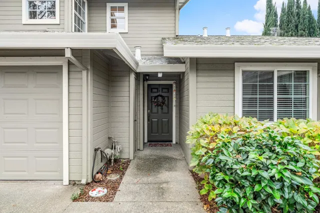 a front view of a house with a garden