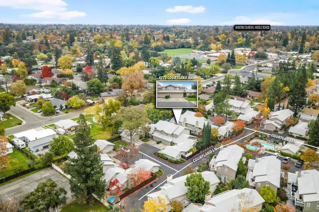 a view of a house with a patio and a yard