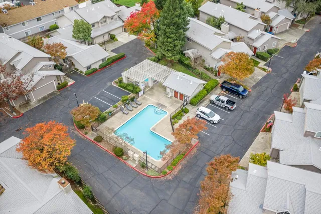 a view of a patio with a table and chairs and potted plants
