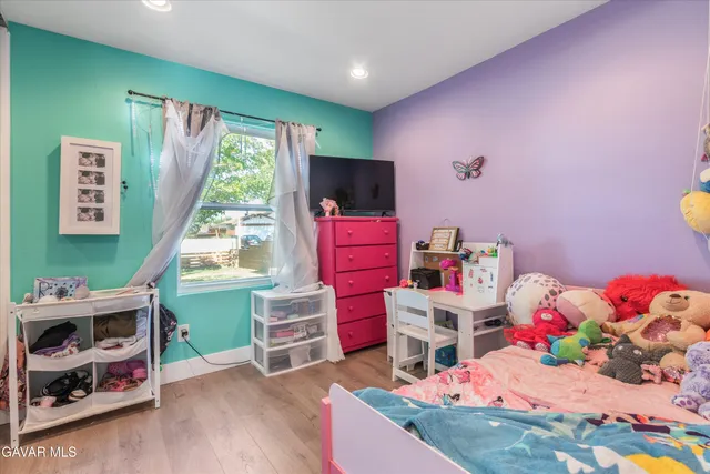 a room with furniture a baby crib and a window