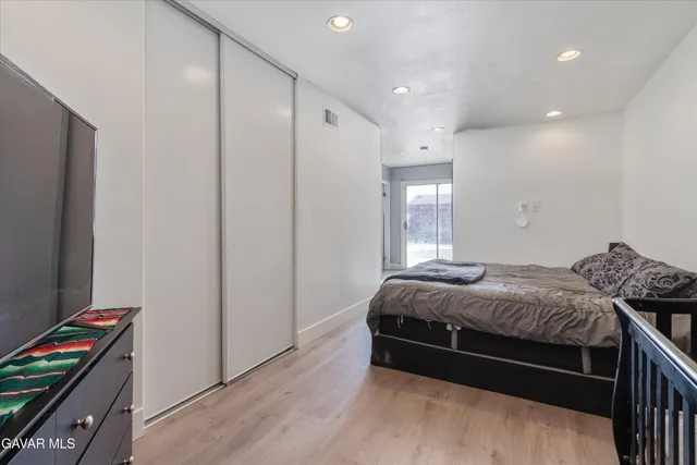 a bed sitting in a bedroom next to a window