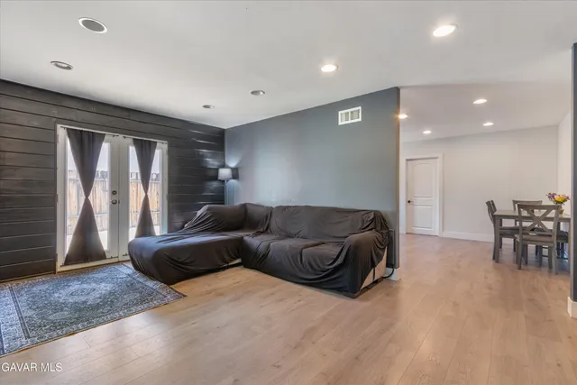 a living room with furniture and a wooden floor