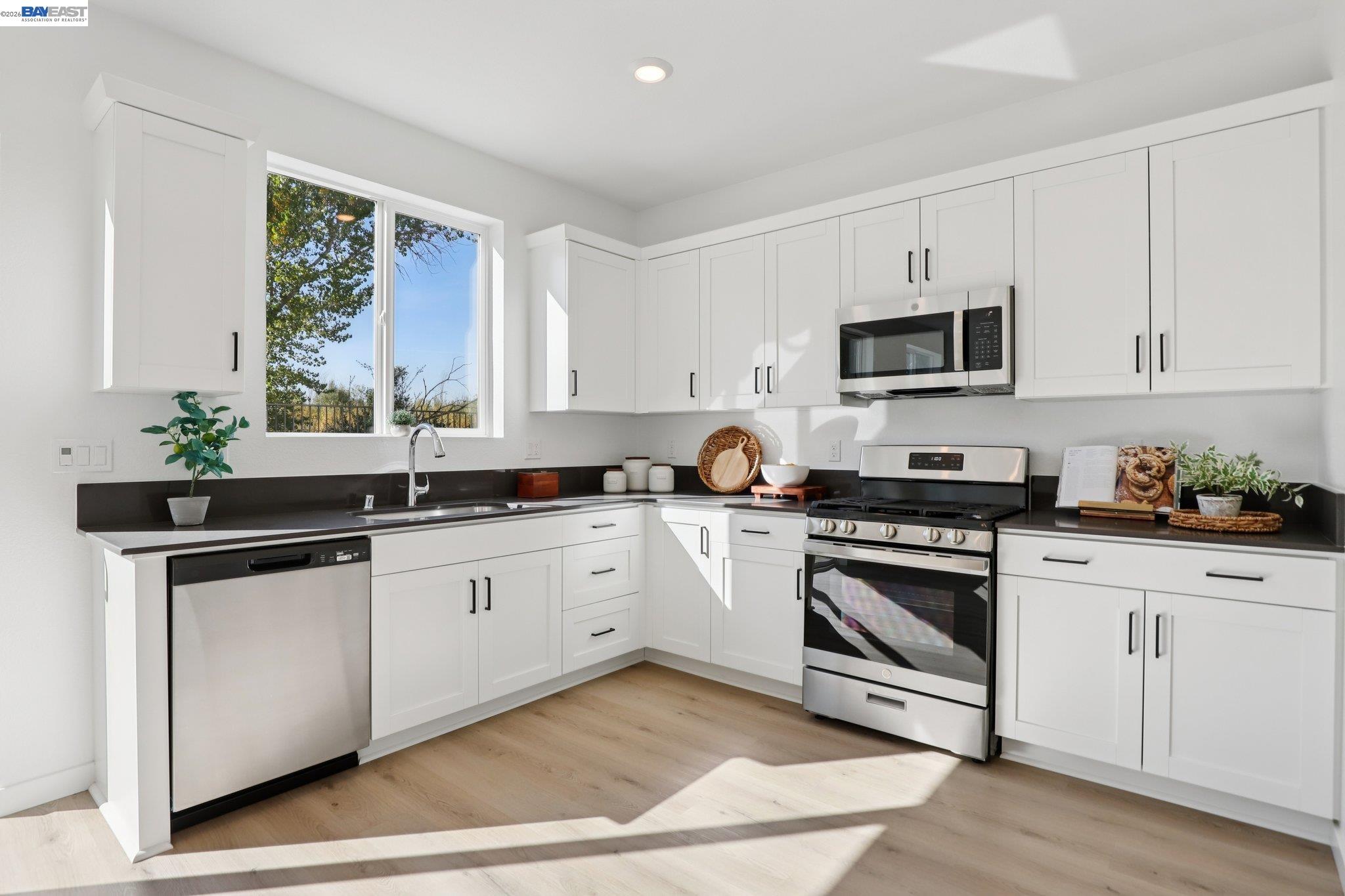 856 Pecan Tree Lane Galt, CA 95632 - Photo 13 of 30 a kitchen with stainless steel appliances white cabinets a sink and a stove