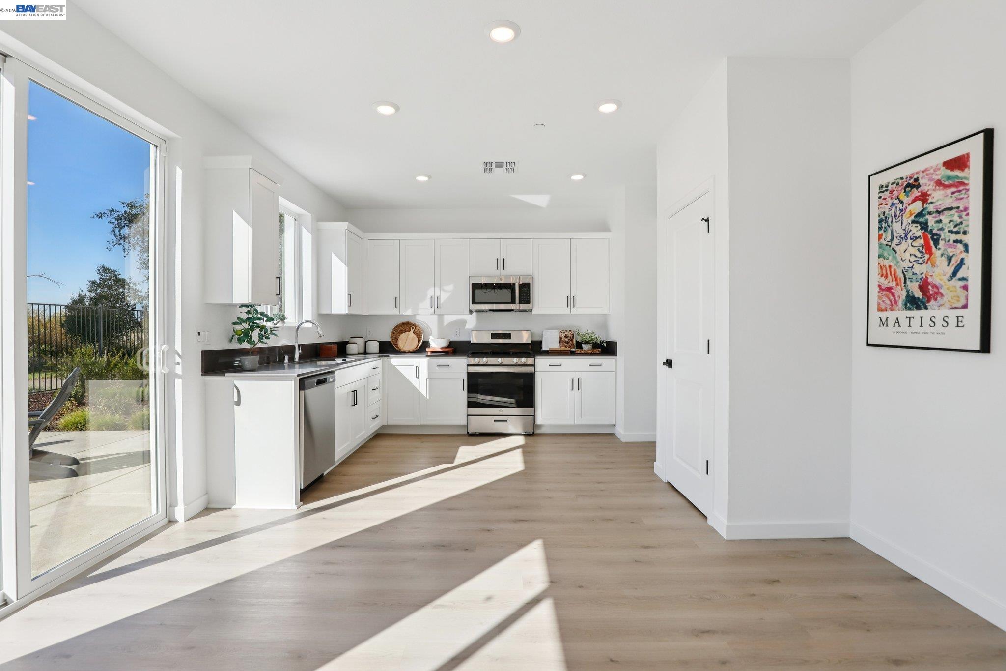 856 Pecan Tree Lane Galt, CA 95632 - Photo 10 of 30 a kitchen with white cabinets and stainless steel appliances