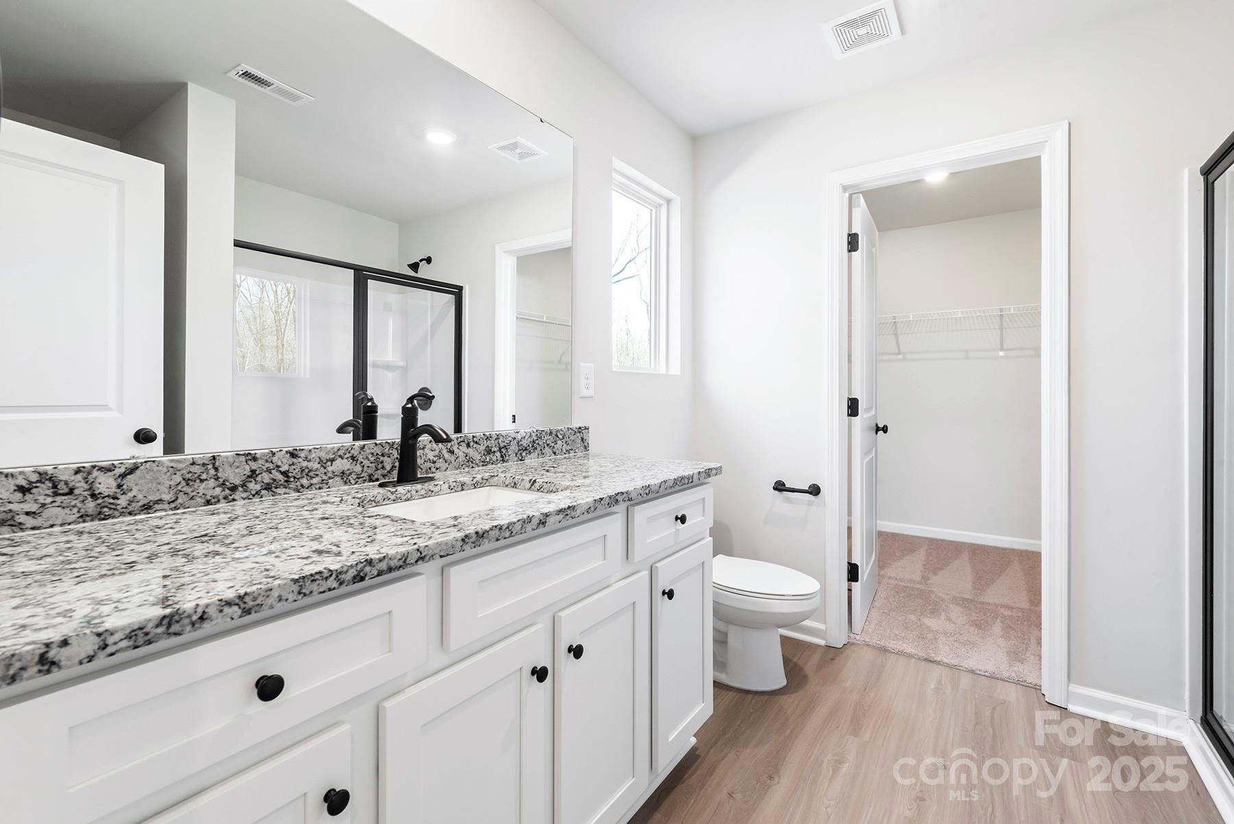 3350 Strong Gastonia, NC 28052 - Photo 14 of 25 a bathroom with a granite countertop sink a toilet a large mirror and shower