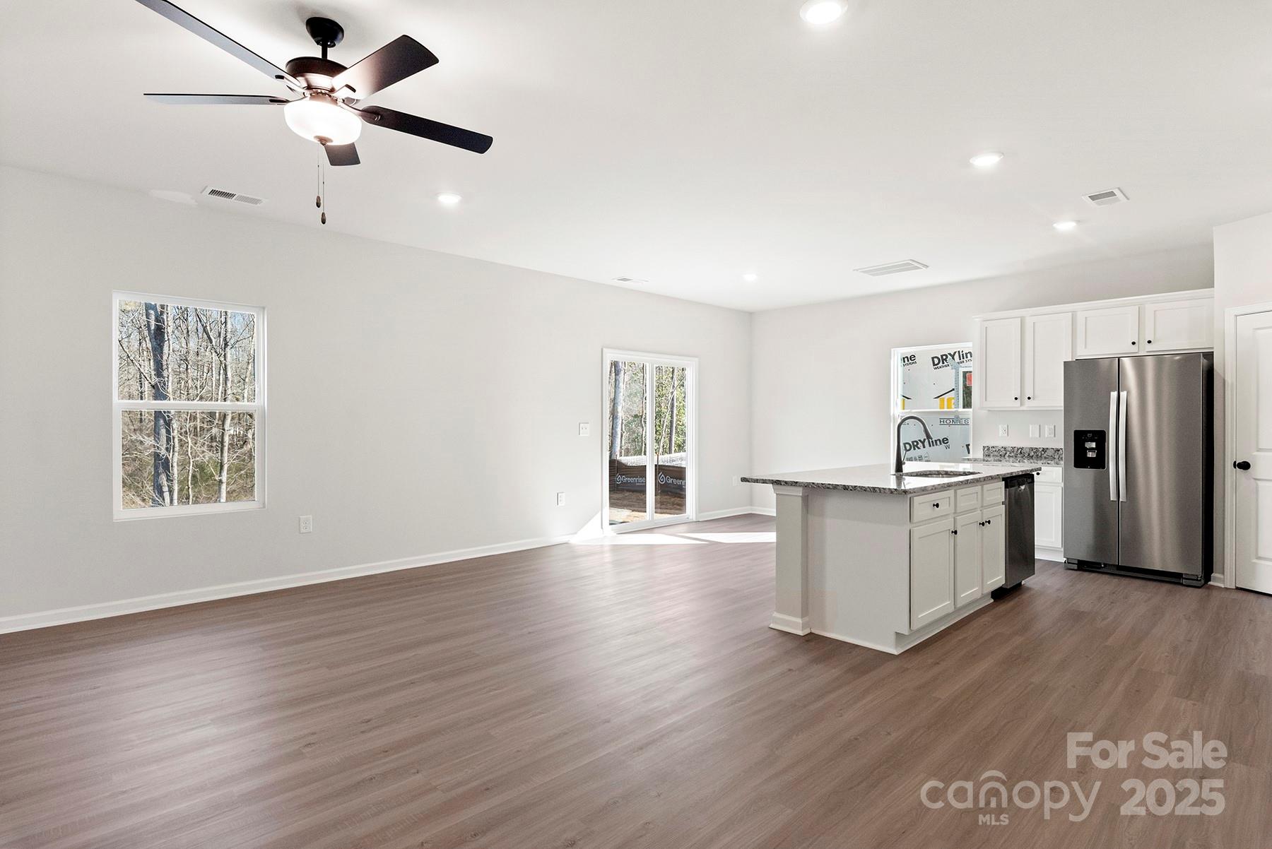 3350 Strong Gastonia, NC 28052 - Photo 4 of 25 a kitchen with stainless steel appliances white cabinets and wooden floor