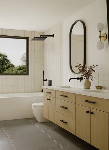 a bathroom with a double vanity sink a mirror and a bathtub