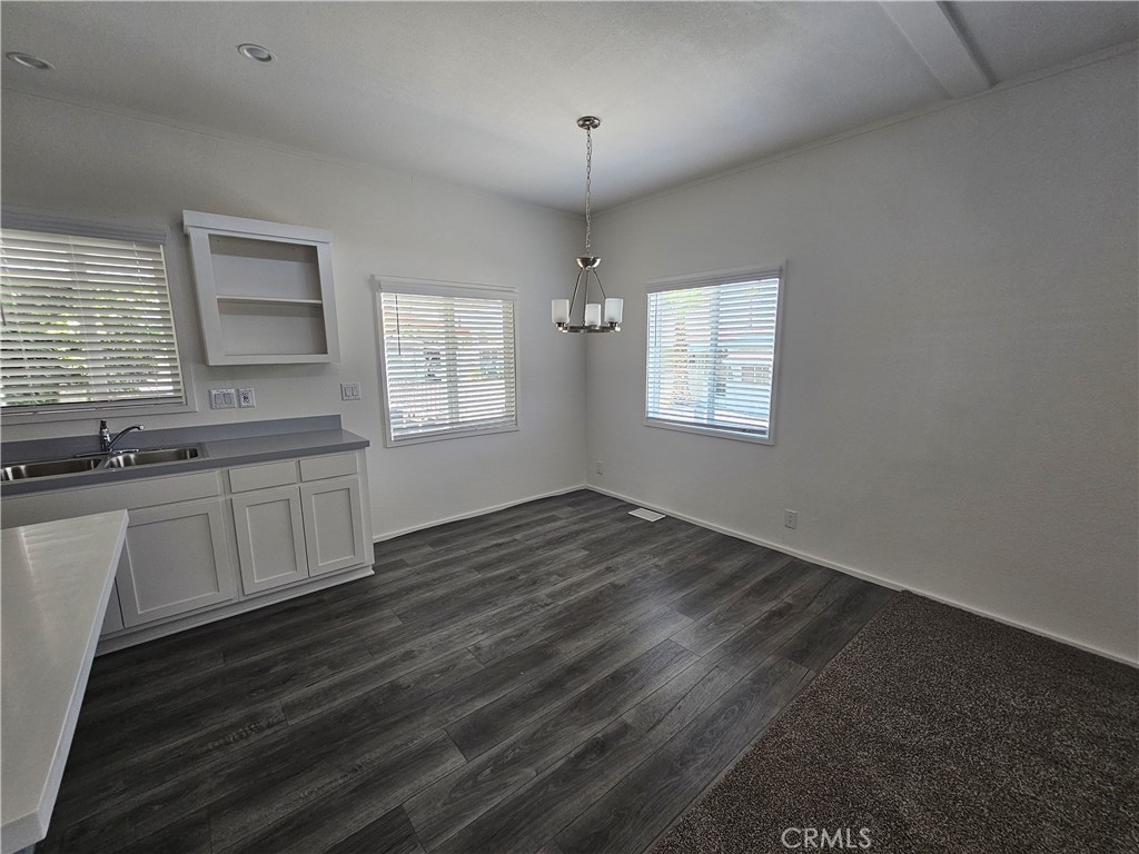 999 South Santa Fe Avenue, Unit 35 San Jacinto, CA 92583 - Photo 16 of 20 an empty room with wooden floor and windows
