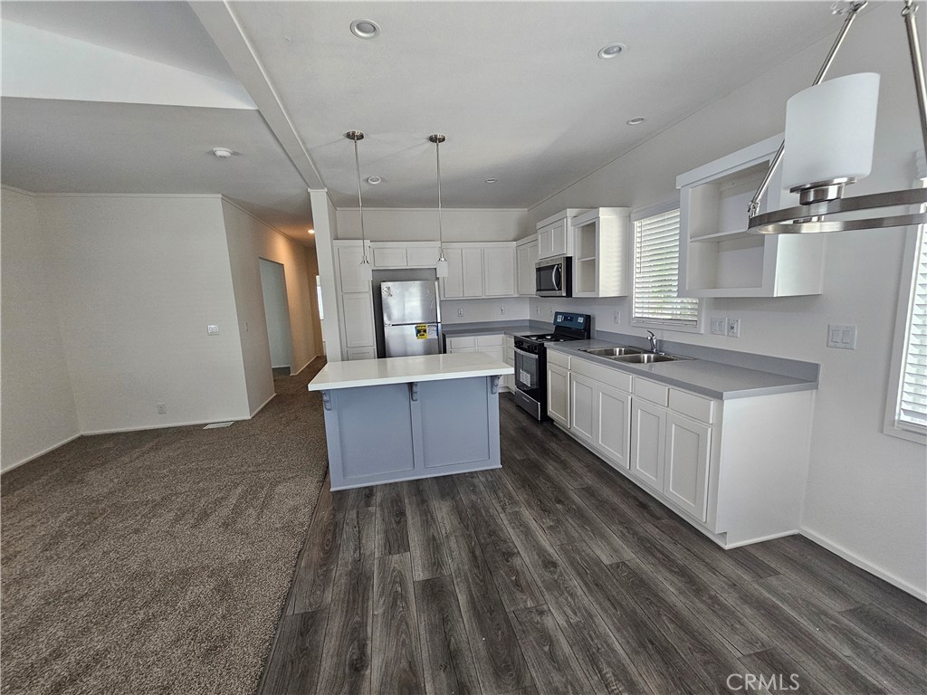 999 South Santa Fe Avenue, Unit 35 San Jacinto, CA 92583 - Photo 18 of 20 a large kitchen with a large window a sink stainless steel appliances and cabinets