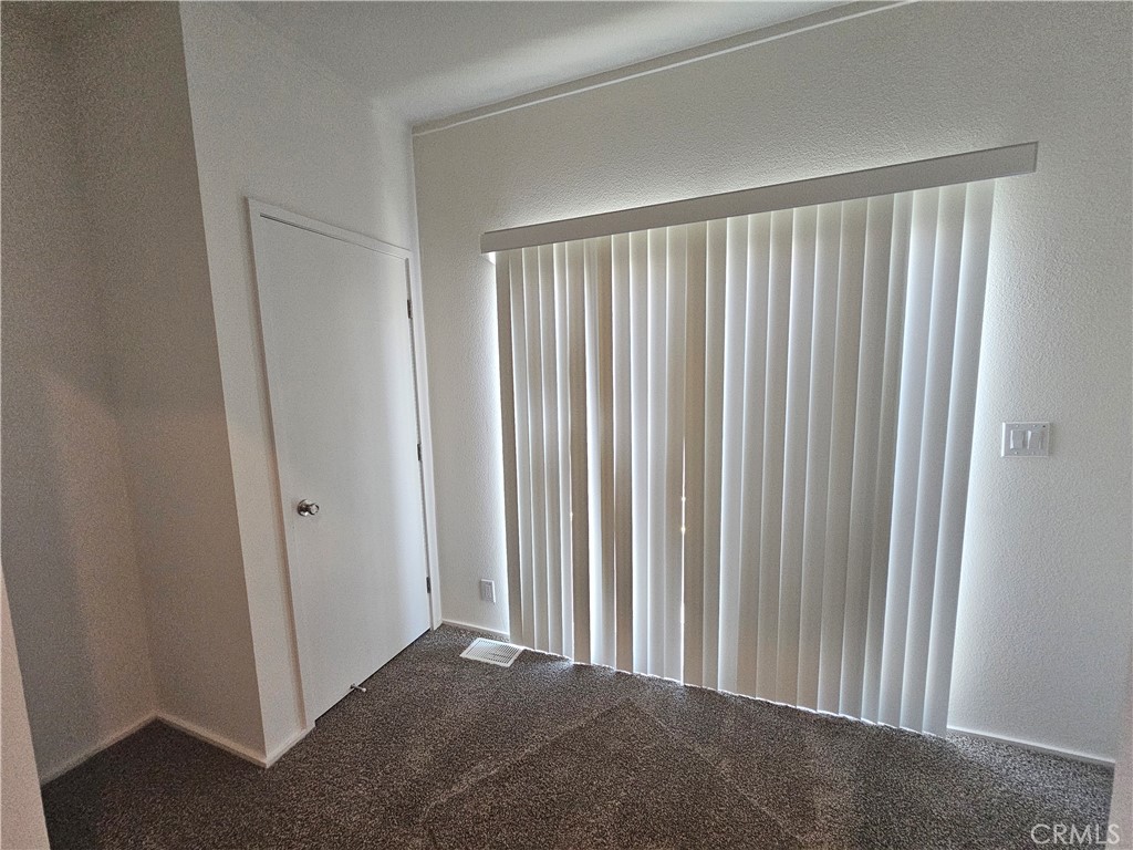 999 South Santa Fe Avenue, Unit 35 San Jacinto, CA 92583 - Photo 7 of 20 a view of a room with a wooden door