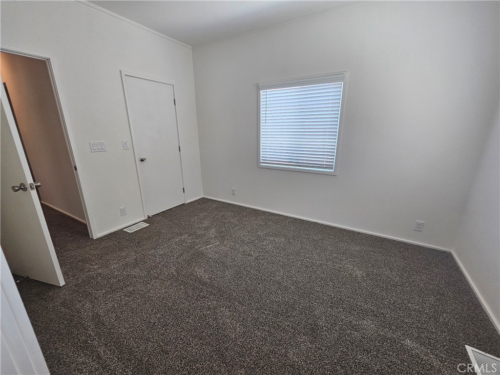 999 South Santa Fe Avenue, Unit 35 San Jacinto, CA 92583 - Photo 9 of 20 an empty room with windows