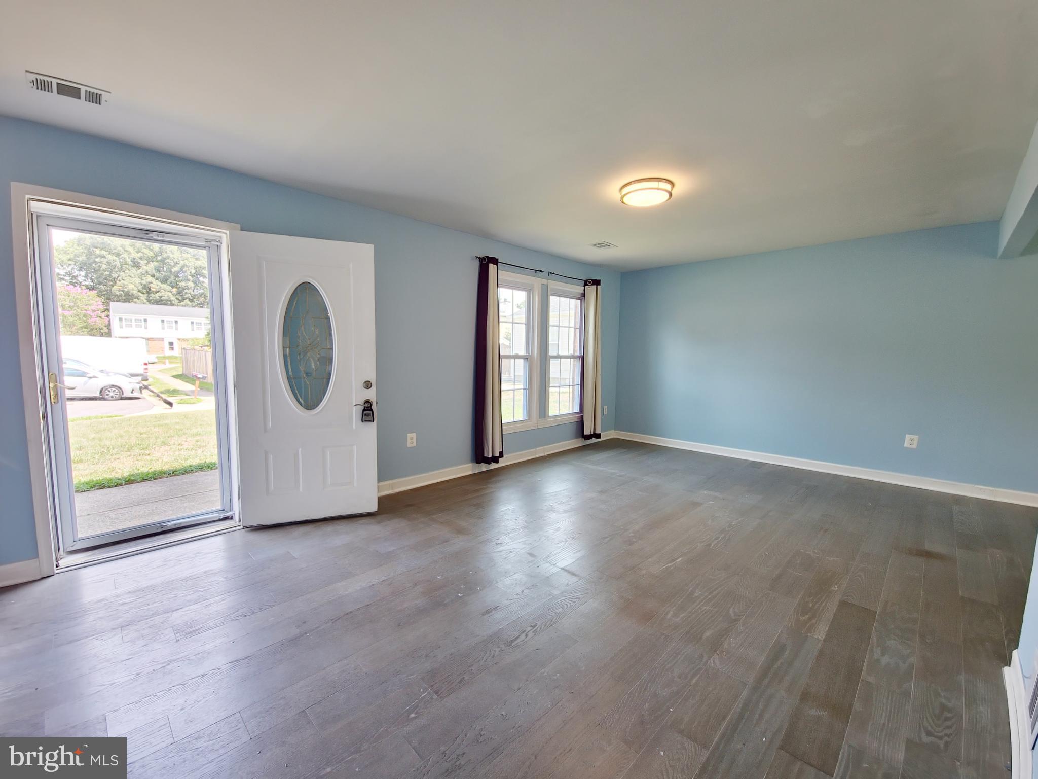 6808 Ben Franklin Road Springfield, VA 22150 - Photo 11 of 34 an empty room with wooden floor and windows