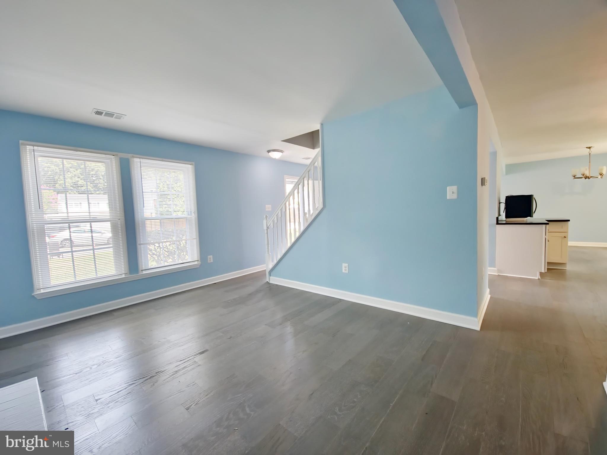 6808 Ben Franklin Road Springfield, VA 22150 - Photo 12 of 34 an empty room with wooden floor and windows