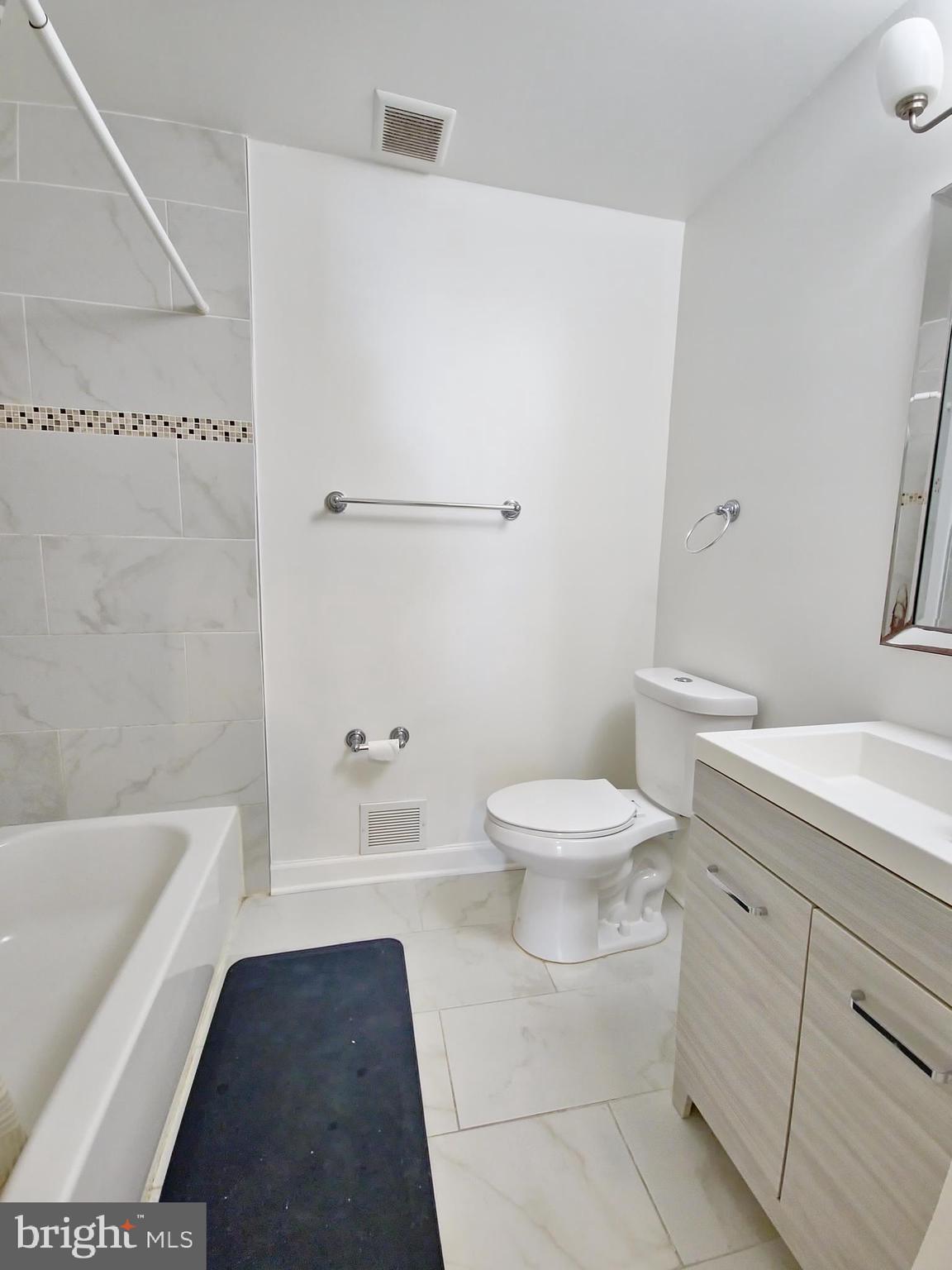 6808 Ben Franklin Road Springfield, VA 22150 - Photo 26 of 34 a white toilet sitting next to a bathroom sink and a bathtub