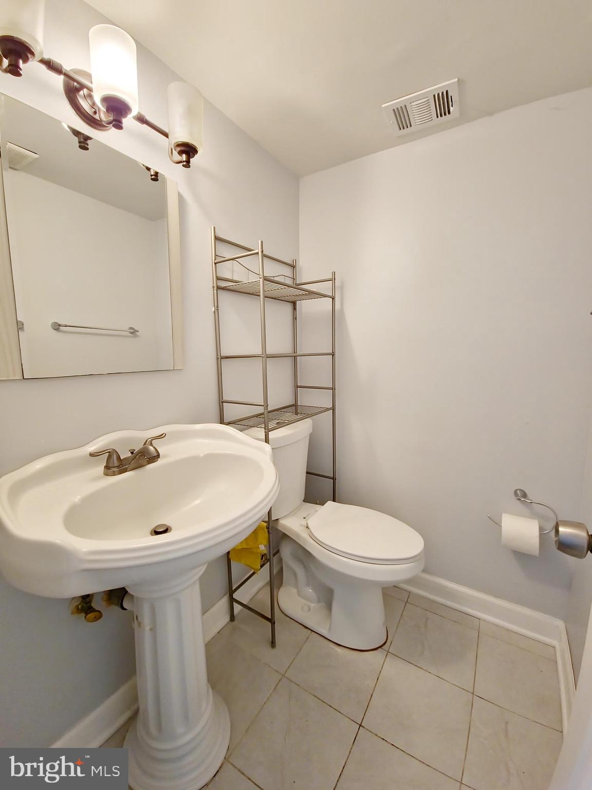 6808 Ben Franklin Road Springfield, VA 22150 - Photo 27 of 34 a bathroom with a sink a toilet and mirror