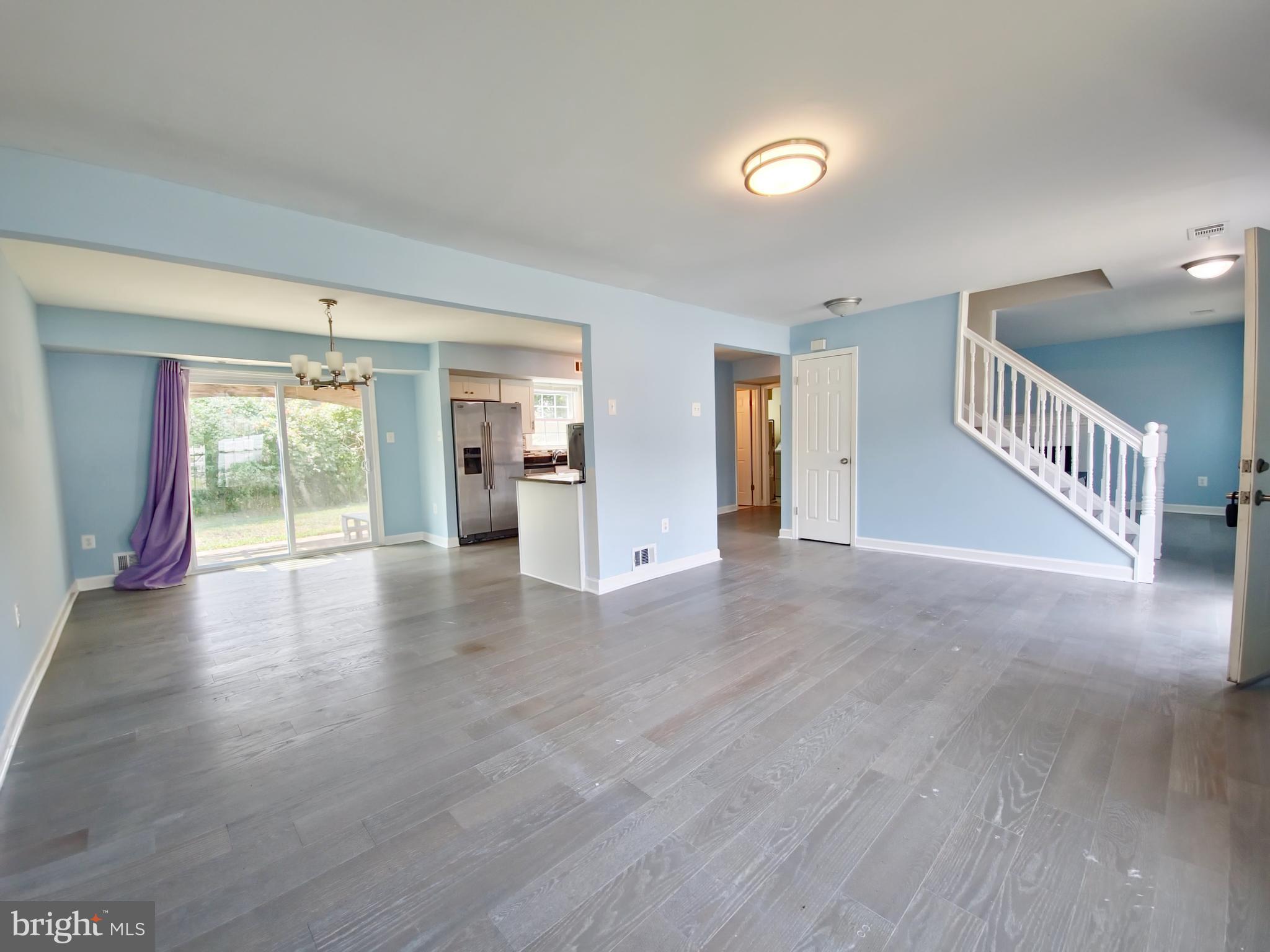 6808 Ben Franklin Road Springfield, VA 22150 - Photo 4 of 34 a view of an empty room with wooden floor and windows