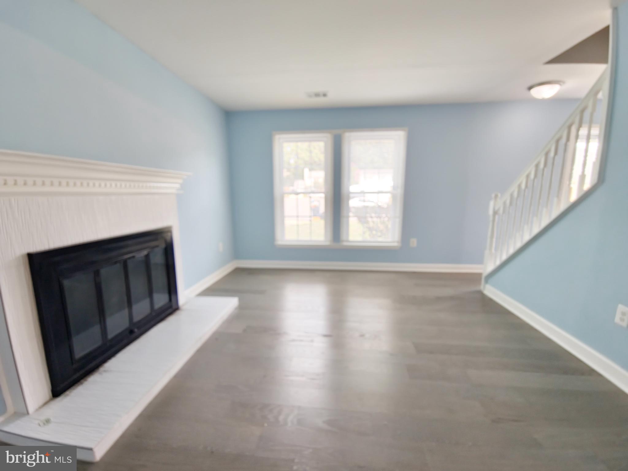 6808 Ben Franklin Road Springfield, VA 22150 - Photo 6 of 34 a view of an empty room with wooden floor and a window