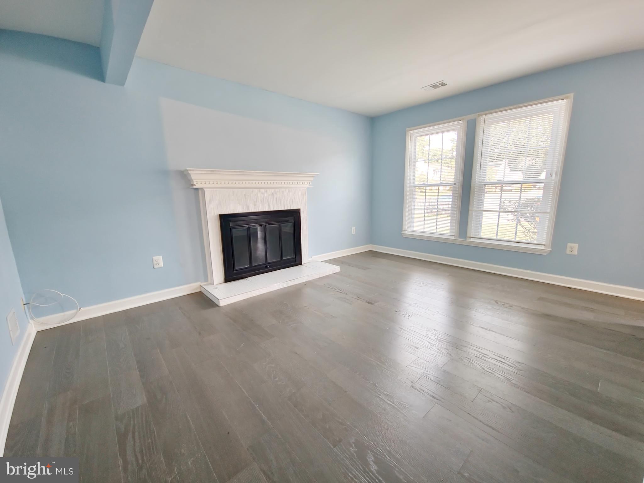 6808 Ben Franklin Road Springfield, VA 22150 - Photo 7 of 34 wooden floor fireplace and windows in an empty room