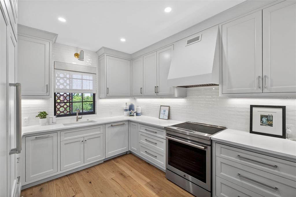 106 South Interlachen Avenue, Unit 518 Winter Park, FL 32789 - Photo 21 of 58 a kitchen with a sink stove and cabinets