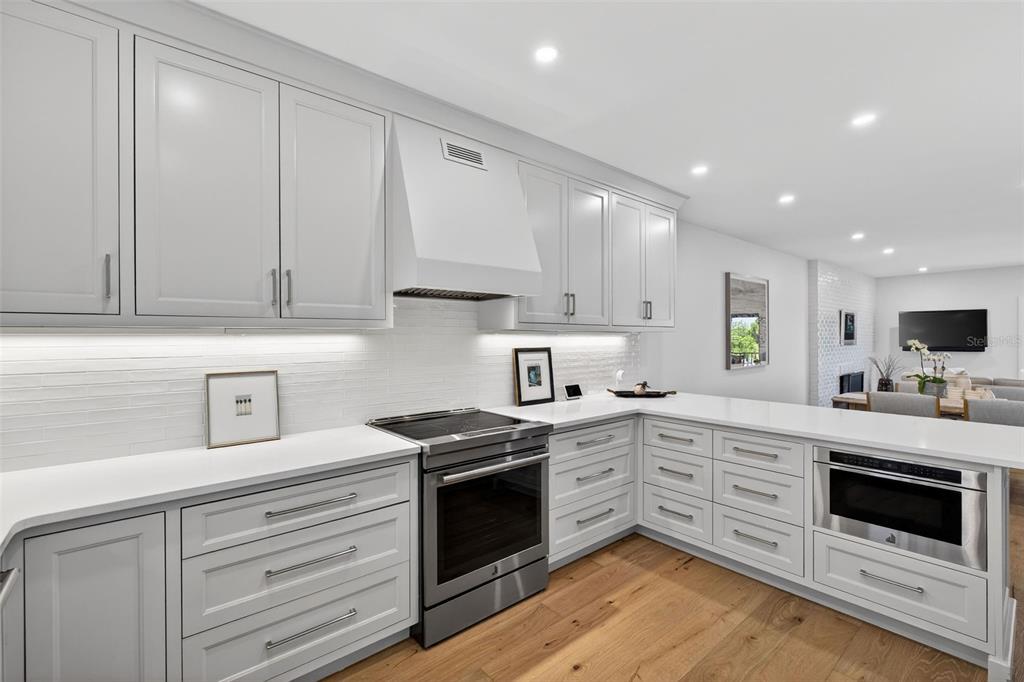 106 South Interlachen Avenue, Unit 518 Winter Park, FL 32789 - Photo 23 of 58 a kitchen with white cabinets and white appliances