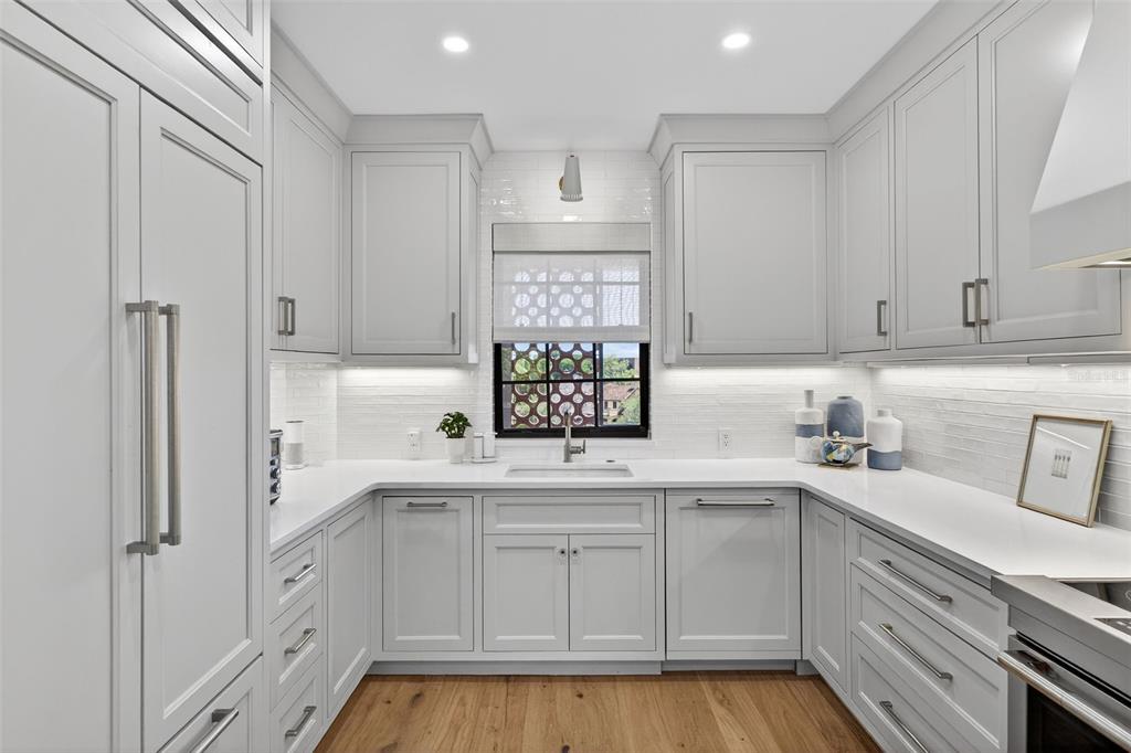 106 South Interlachen Avenue, Unit 518 Winter Park, FL 32789 - Photo 24 of 58 a kitchen with white cabinets and sink