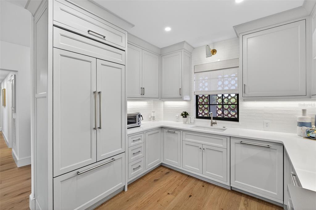 106 South Interlachen Avenue, Unit 518 Winter Park, FL 32789 - Photo 26 of 58 a kitchen with white cabinets and white appliances