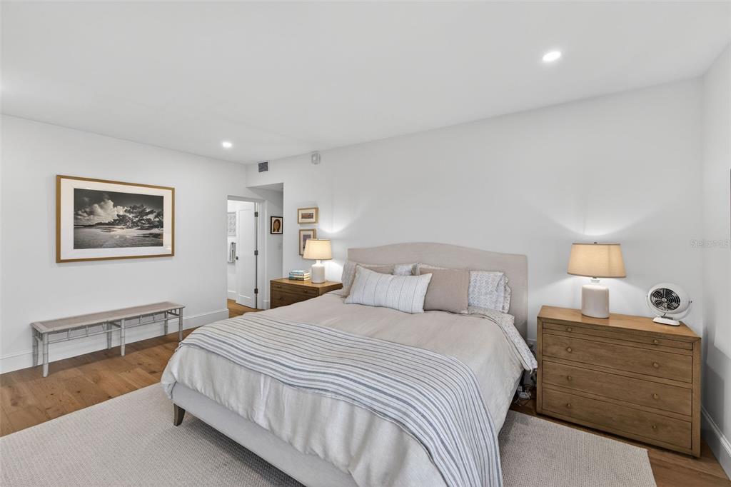 106 South Interlachen Avenue, Unit 518 Winter Park, FL 32789 - Photo 29 of 58 a bedroom with a bed and a lamp on table