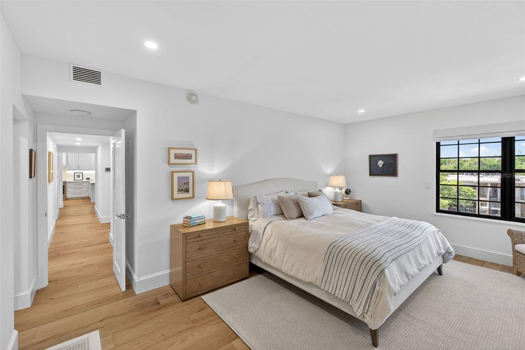 106 South Interlachen Avenue, Unit 518 Winter Park, FL 32789 - Photo 30 of 58 a bedroom with a bed and wooden floor