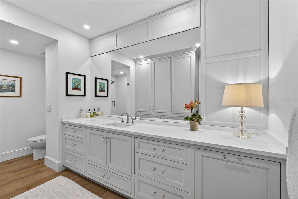 106 South Interlachen Avenue, Unit 518 Winter Park, FL 32789 - Photo 35 of 58 a bathroom with a double vanity sink and a mirror