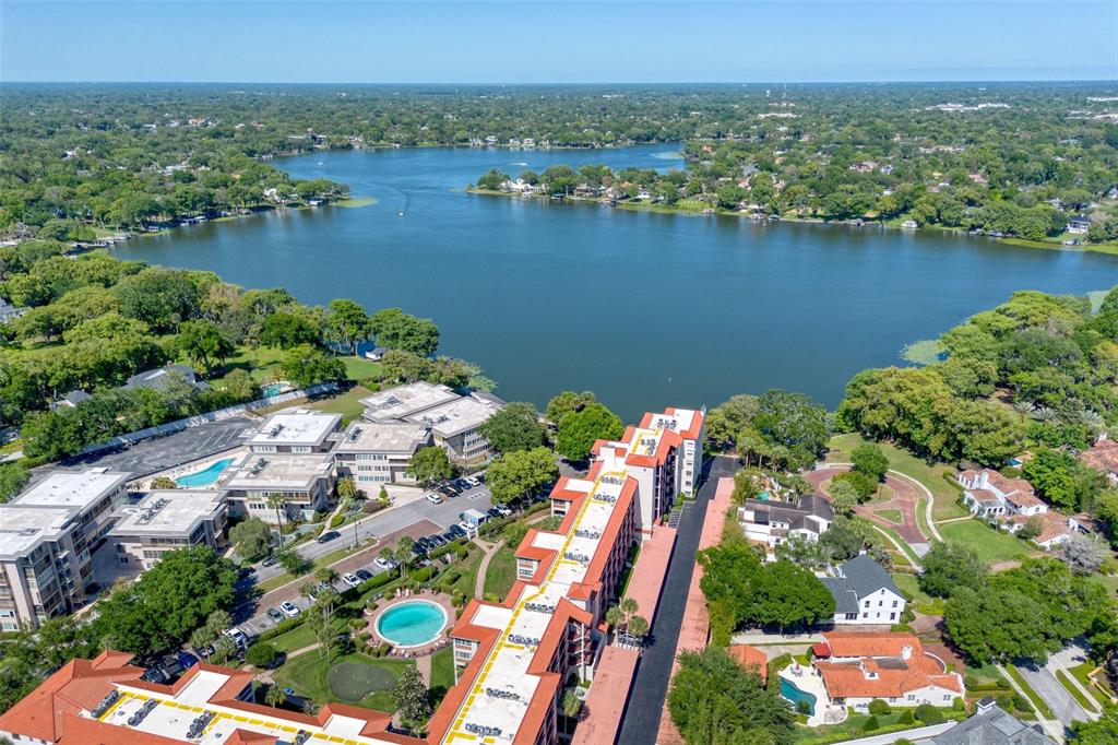 106 South Interlachen Avenue, Unit 518 Winter Park, FL 32789 - Photo 52 of 58 an aerial view of lake and residential houses with outdoor space