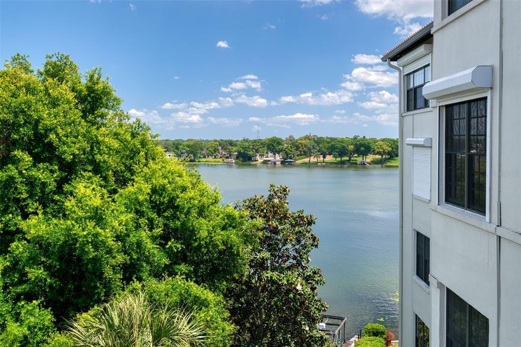 106 South Interlachen Avenue, Unit 518 Winter Park, FL 32789 - Photo 8 of 58 a view of a lake with a building in the background