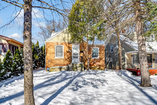 a view of a house with snow on the road