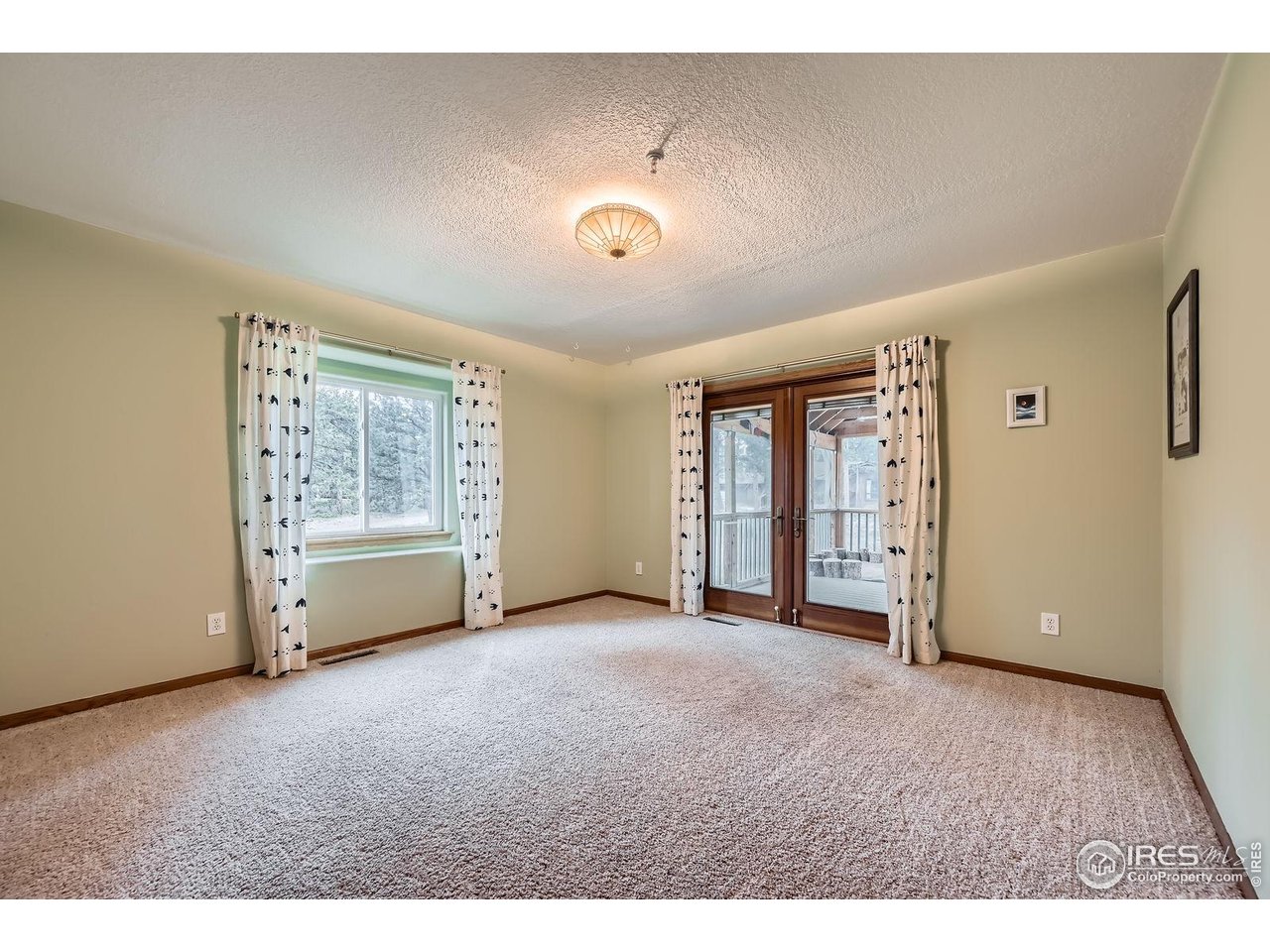 613 Ranch Road Ward, CO 80481 - Photo 14 of 37 Large bedroom on the main floor - walks out to fully screened porch