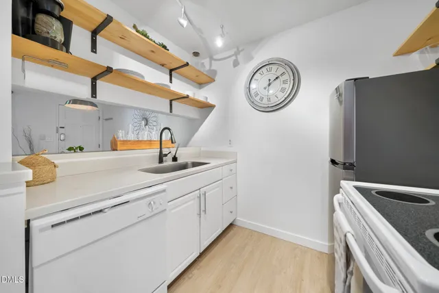 a kitchen with a refrigerator and a sink
