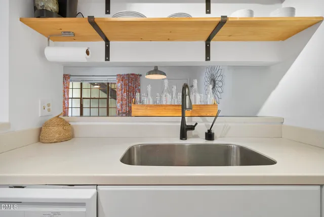 a kitchen with kitchen island a sink and a stove