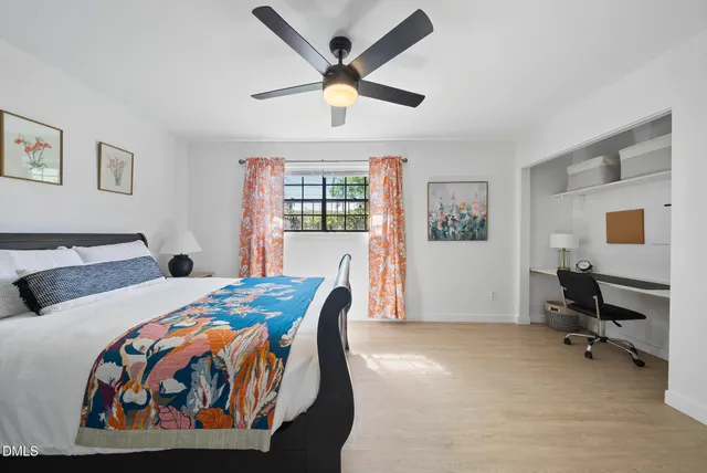 a bedroom with a bed and a desk